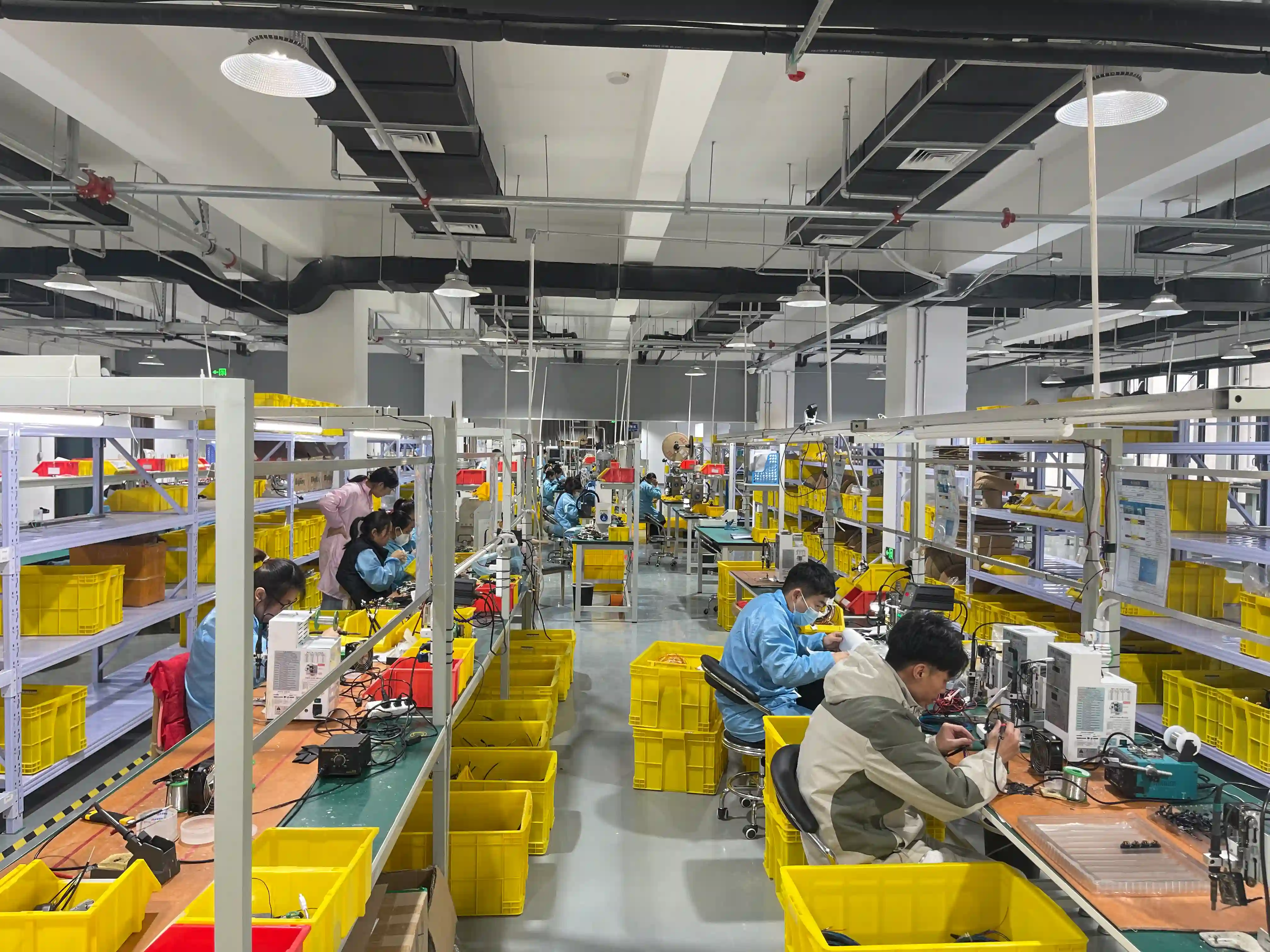 Wire harness manufacturing facility with quality control inspection